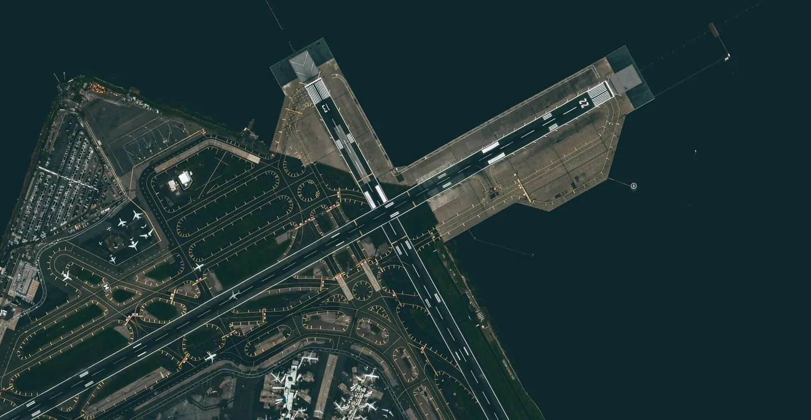 Dark aerial view of an industrial area with intersecting roads and structures